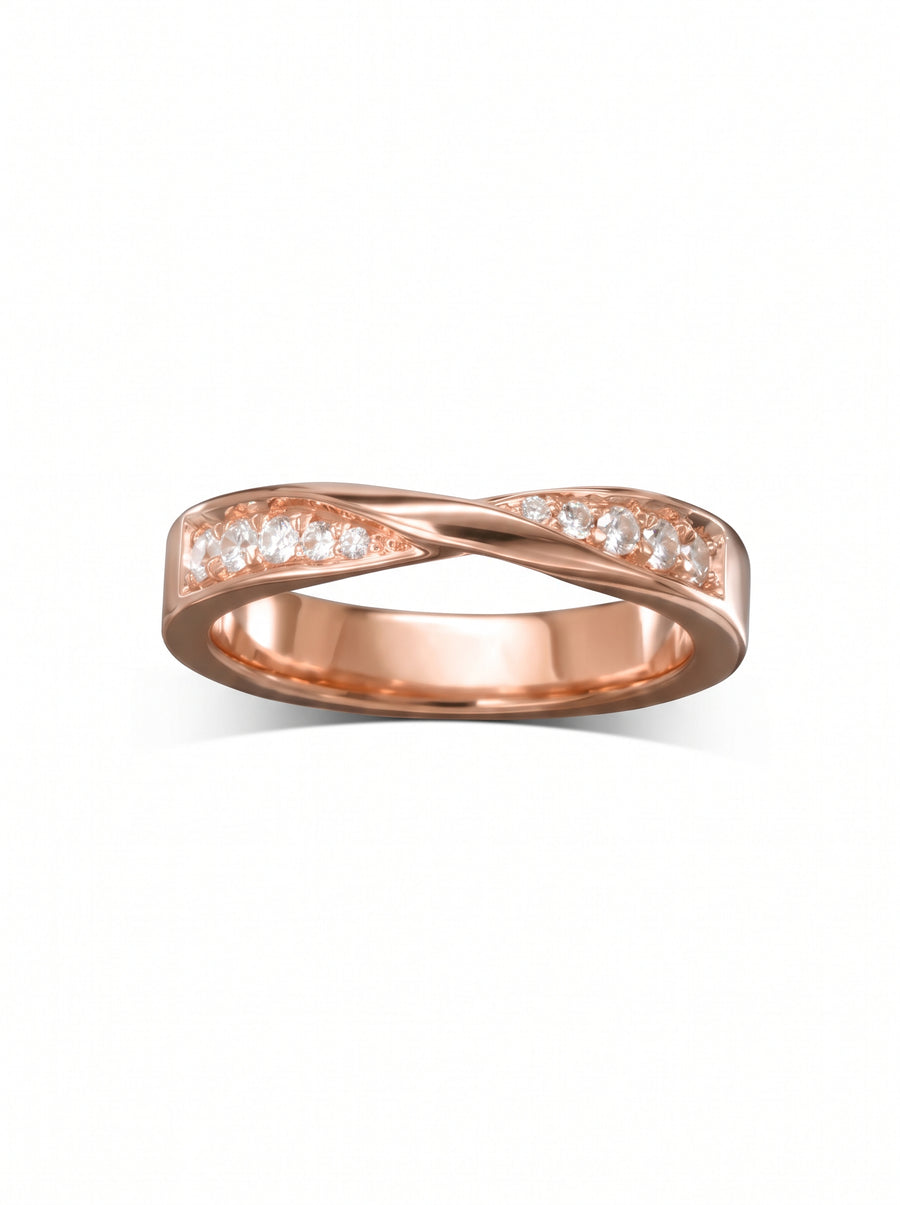 Rose gold wedding ring with a twisted band design and channel-set round diamonds.