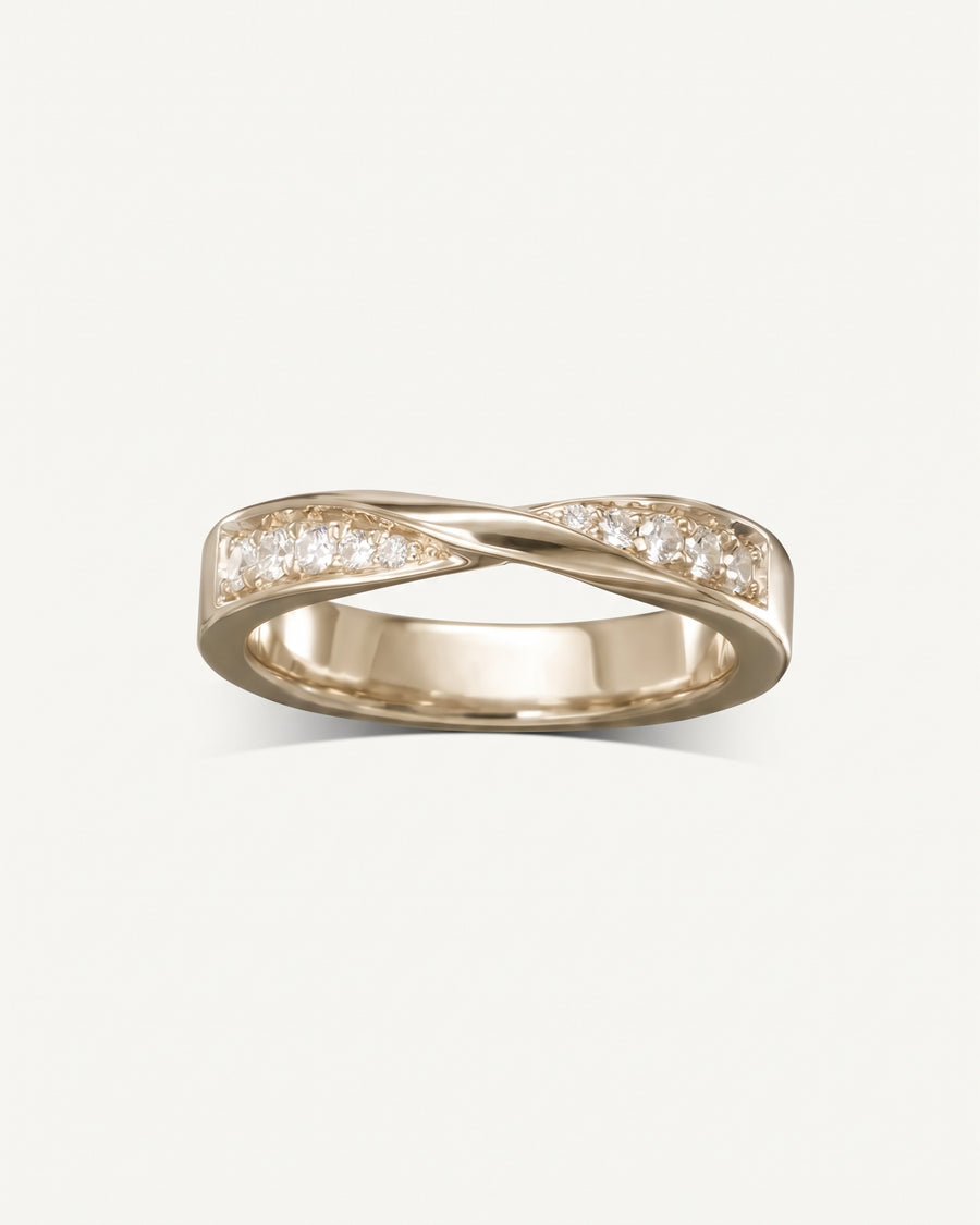 Rose gold wedding ring with a twisted band design and embedded round white diamonds.