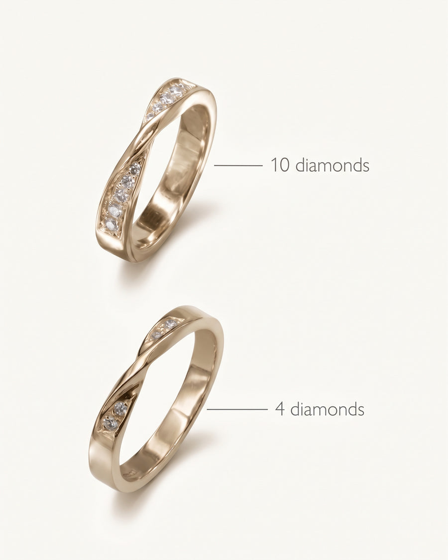 Two gold wedding rings with a twisted design, featuring either ten or four small inset diamonds.