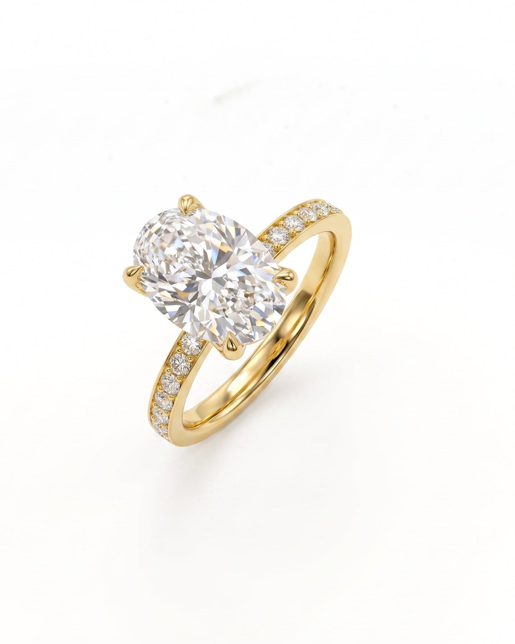 A yellow gold solitaire engagement ring featuring a large oval-cut diamond center stone and a pavé-set diamond band, shown on a clean white background.