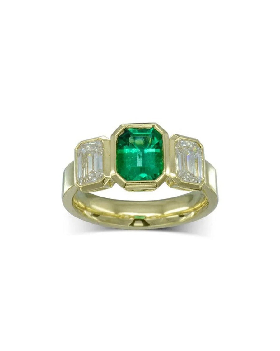 18ct yellow gold trilogy ring with a central emerald and two baguette diamonds.