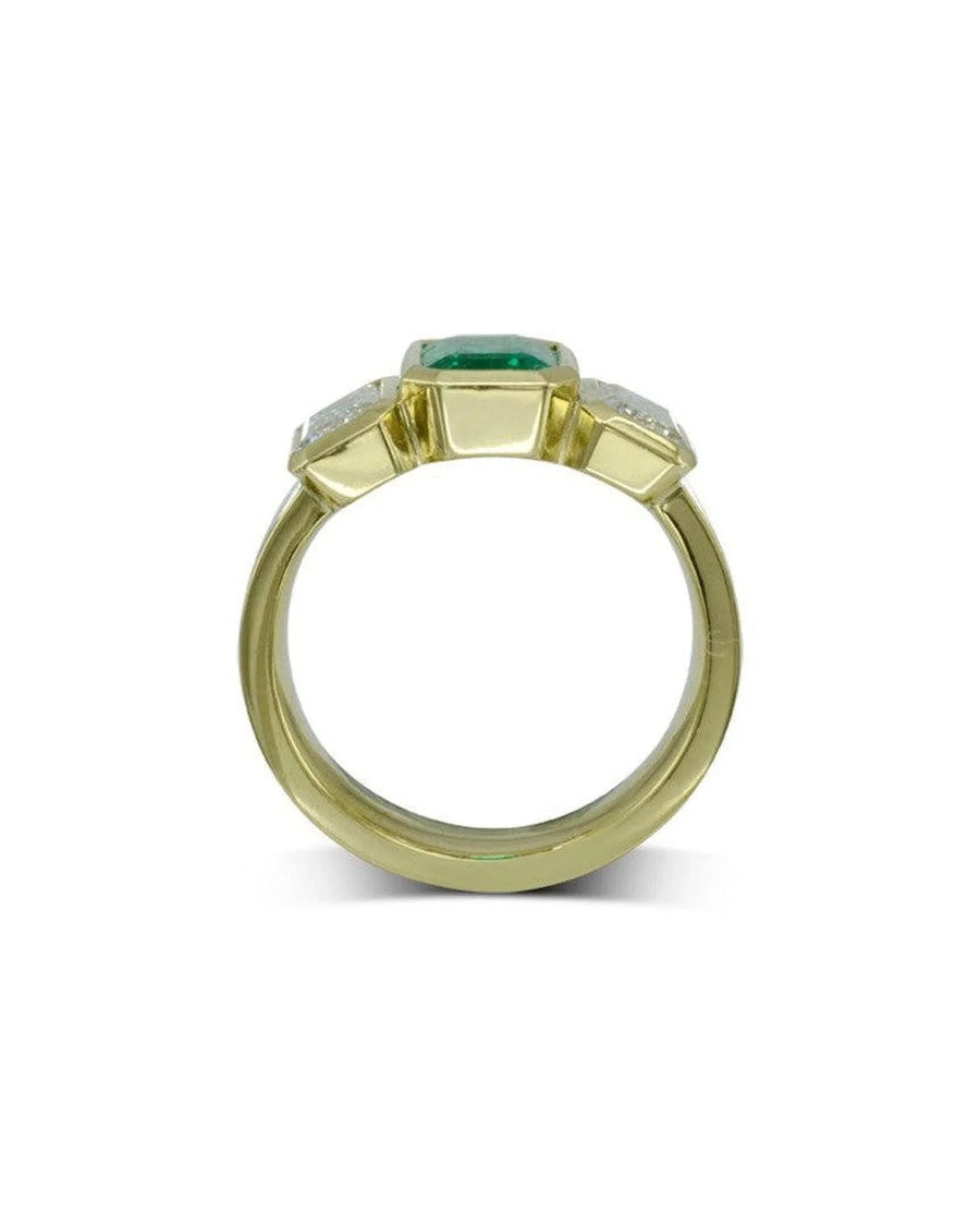 Yellow gold ring with a central emerald and two side diamonds.