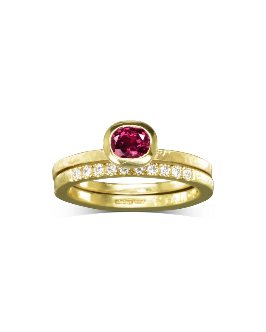 Handmade gold ring set with ruby centre stone and diamond band, featuring organic textures