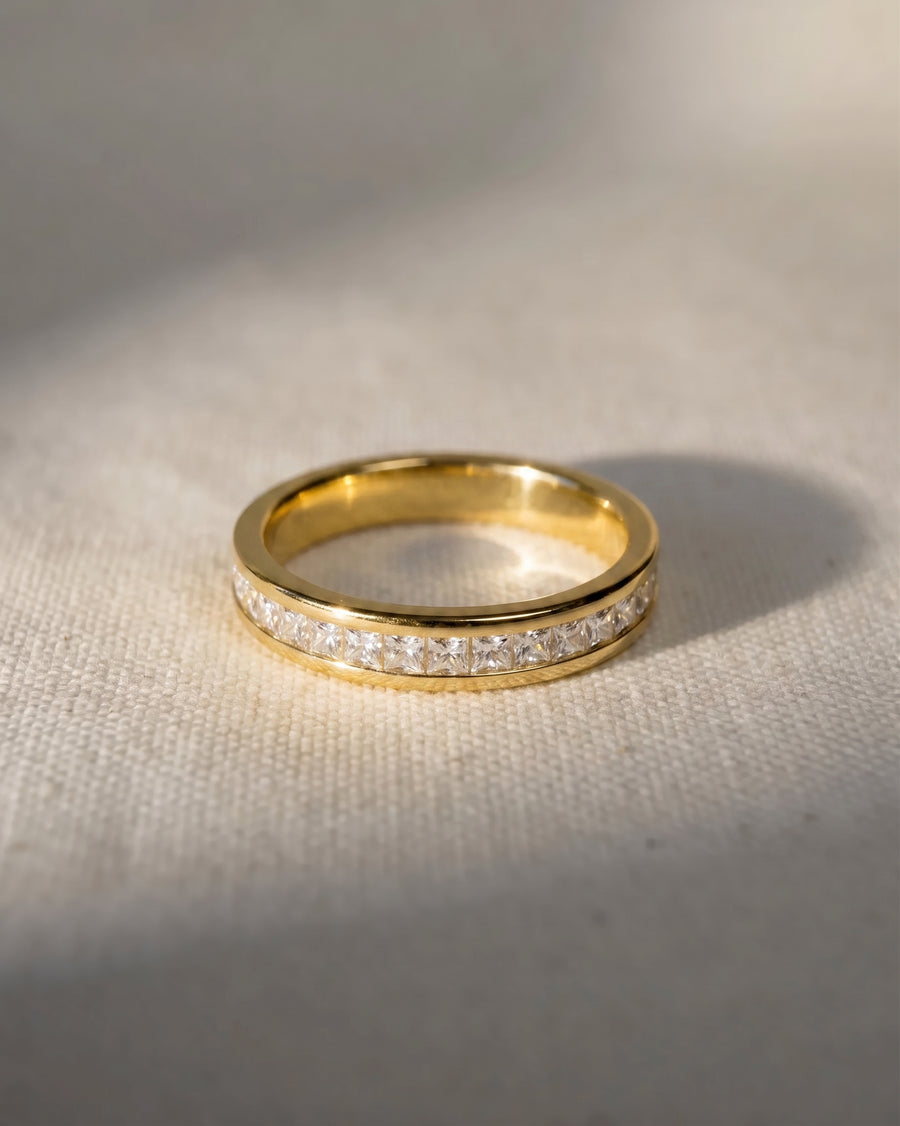Yellow gold ring with princess cut diamonds.