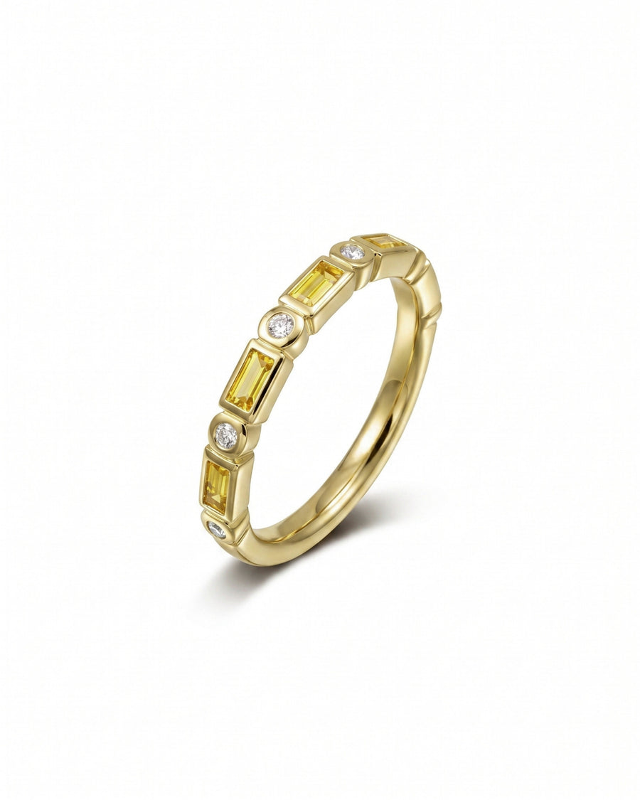 Yellow gold eternity ring with baguette yellow sapphires and round diamonds.