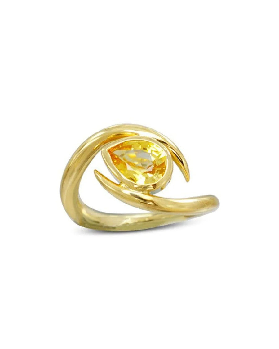 Yellow sapphire gold ring with organic, curved design on white background